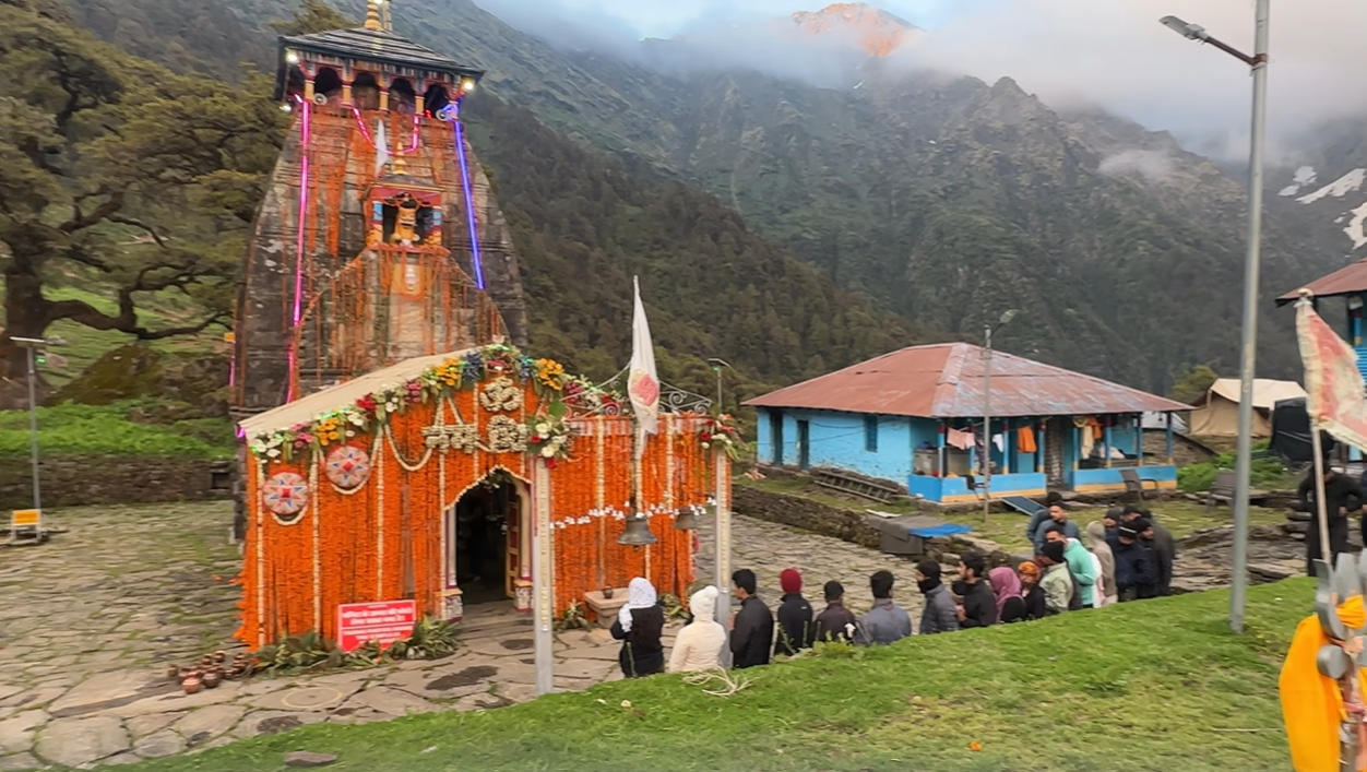 Pilgrims queuing outside the decorated Madhyamaheshwar Temple at dusk