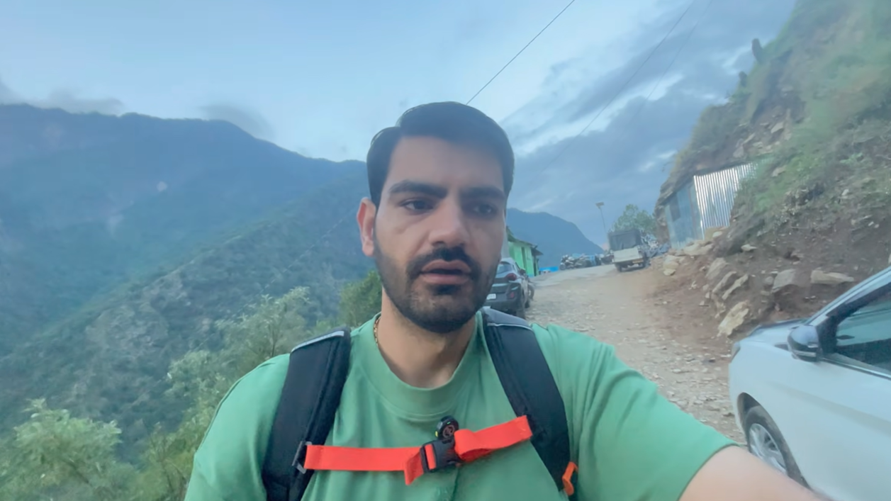 Creator wearing a backpack near the Ransi roadhead before the trek