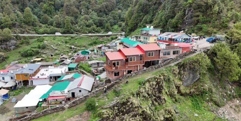 Aerial view of the cliffside buildings of Moon Rock Cafe and Stay near Chopta
