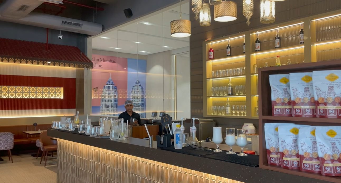 Bar counter and illuminated shelves inside Mustard Madras Sector 58