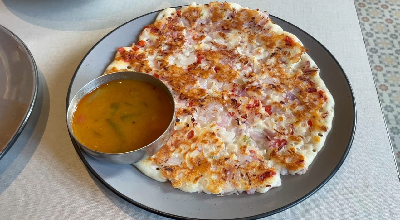 Onion-topped South Indian dish with sambar at Mustard Madras Gurgaon