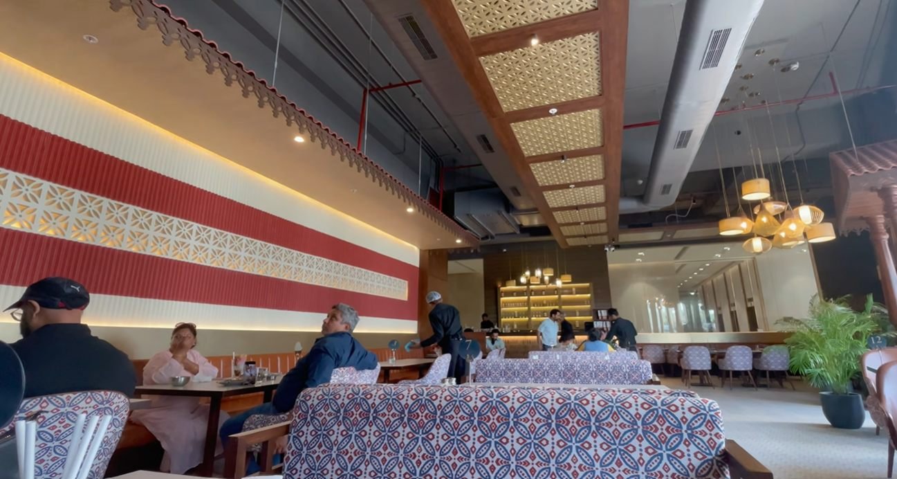 Dining room with patterned chairs at Mustard Madras Gurgaon