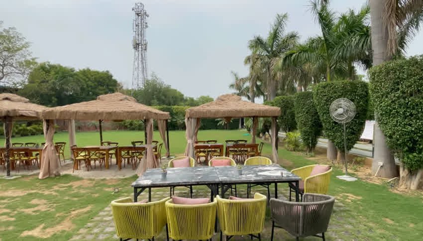 Thatched cabanas and open-air tables on the lawn at The Sunroom