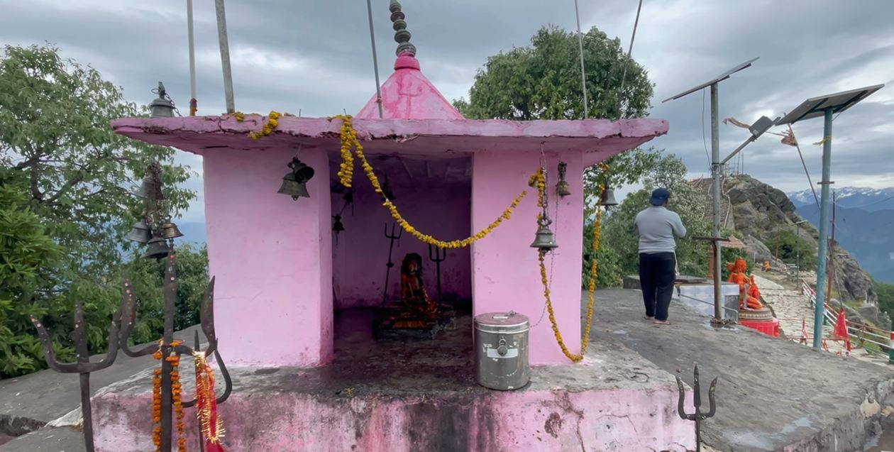 Small pink shrine with bells near Kartik Swami Temple