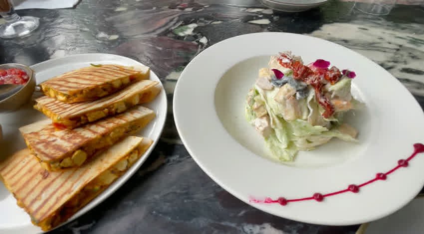 Quesadilla slices beside a creamy salad at The Sunroom