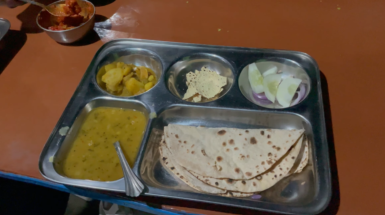 Thali with rotis, dal, vegetable curry, papad and sliced onions at our Ransi stop