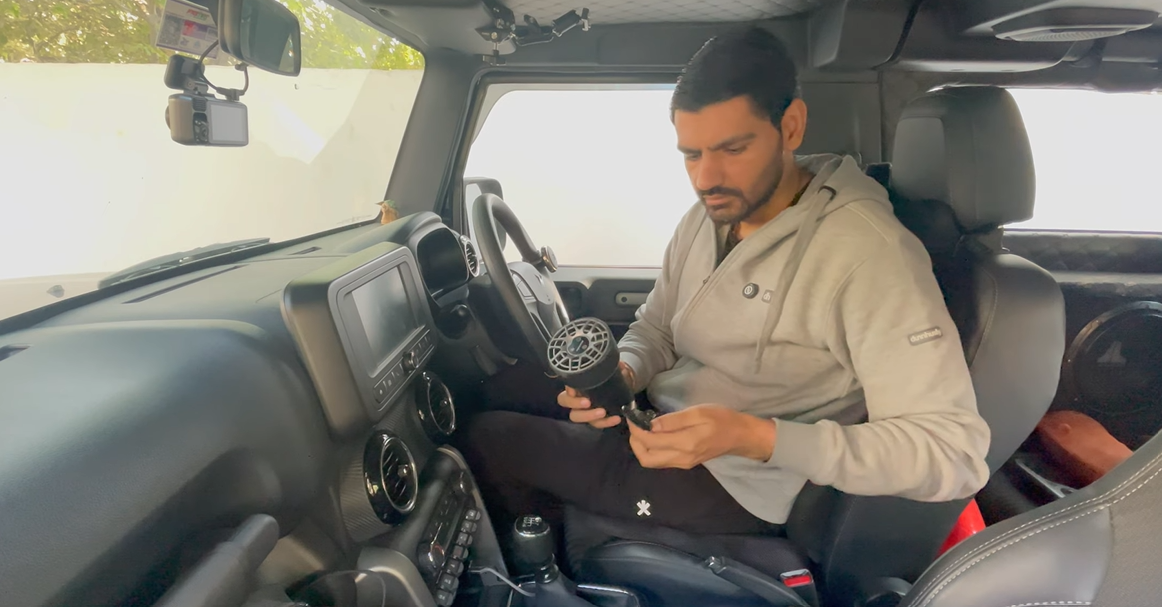 Naveen connecting the USB-C power cable to the Reffair AX50 car air purifier