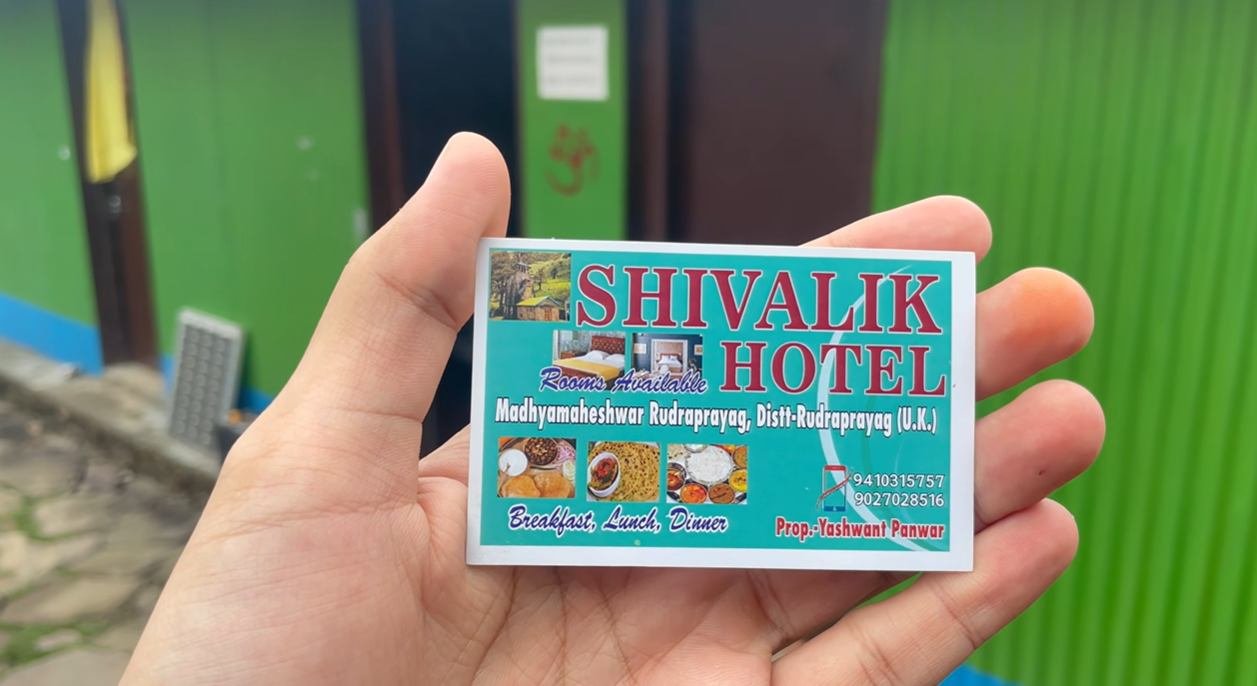 Shivalik Hotel business card held outside the property