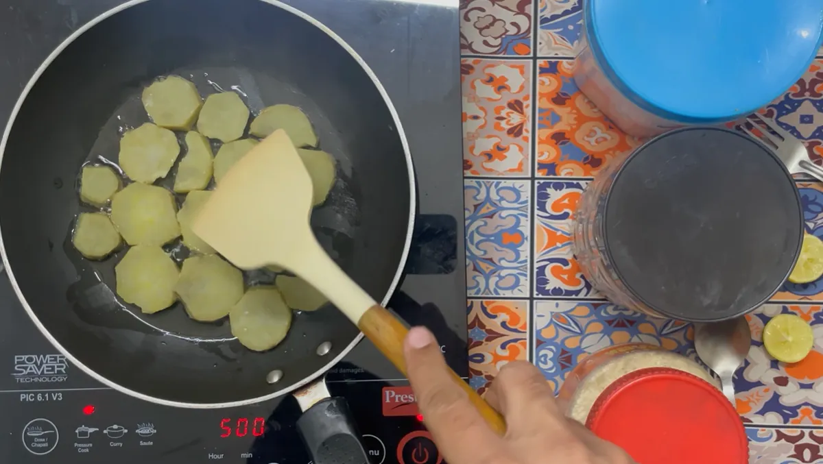 Boiled sweet potato slices shallow-frying in desi ghee