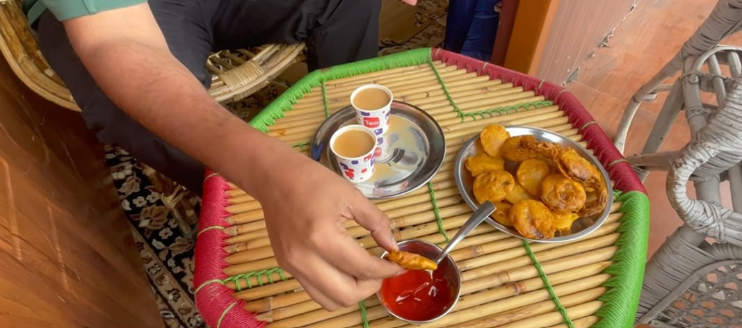 Tea and fried snacks on a low table at Moon Rock Cafe