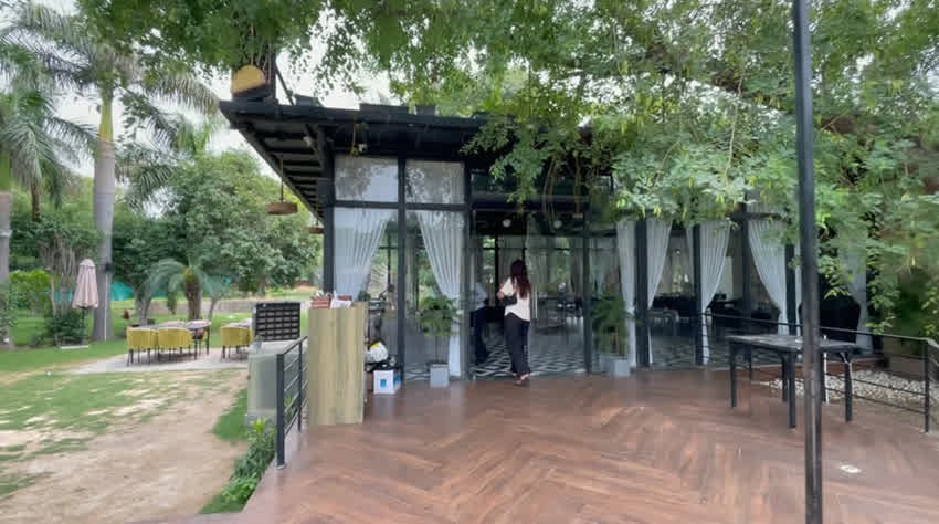 Glass-walled dining room entrance and wooden deck at The Sunroom