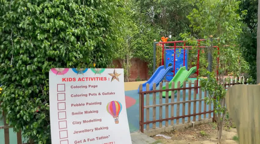 Children's play area with slides and a kids activities sign at The Sunroom
