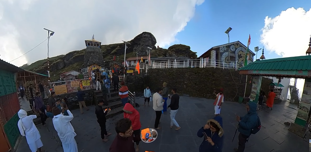 Visitors standing across the paved Tungnath Temple complex